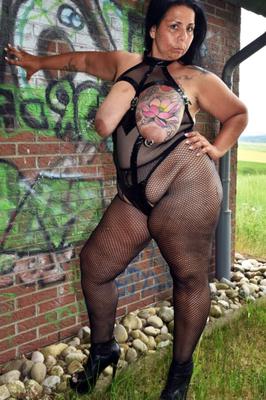 BBW flashing outdoors in fishnet