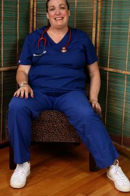 Chubby mature Lisa strips off her nurse uniform.